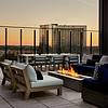 Outdoor fireplace with seating and view of downtown 