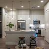 white kitchen with island and pendant lights