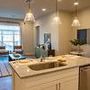 Kitchen island with pendant lighting opening to living area
