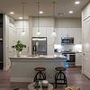 Open kitchen with stainless steel appliances and island seating
