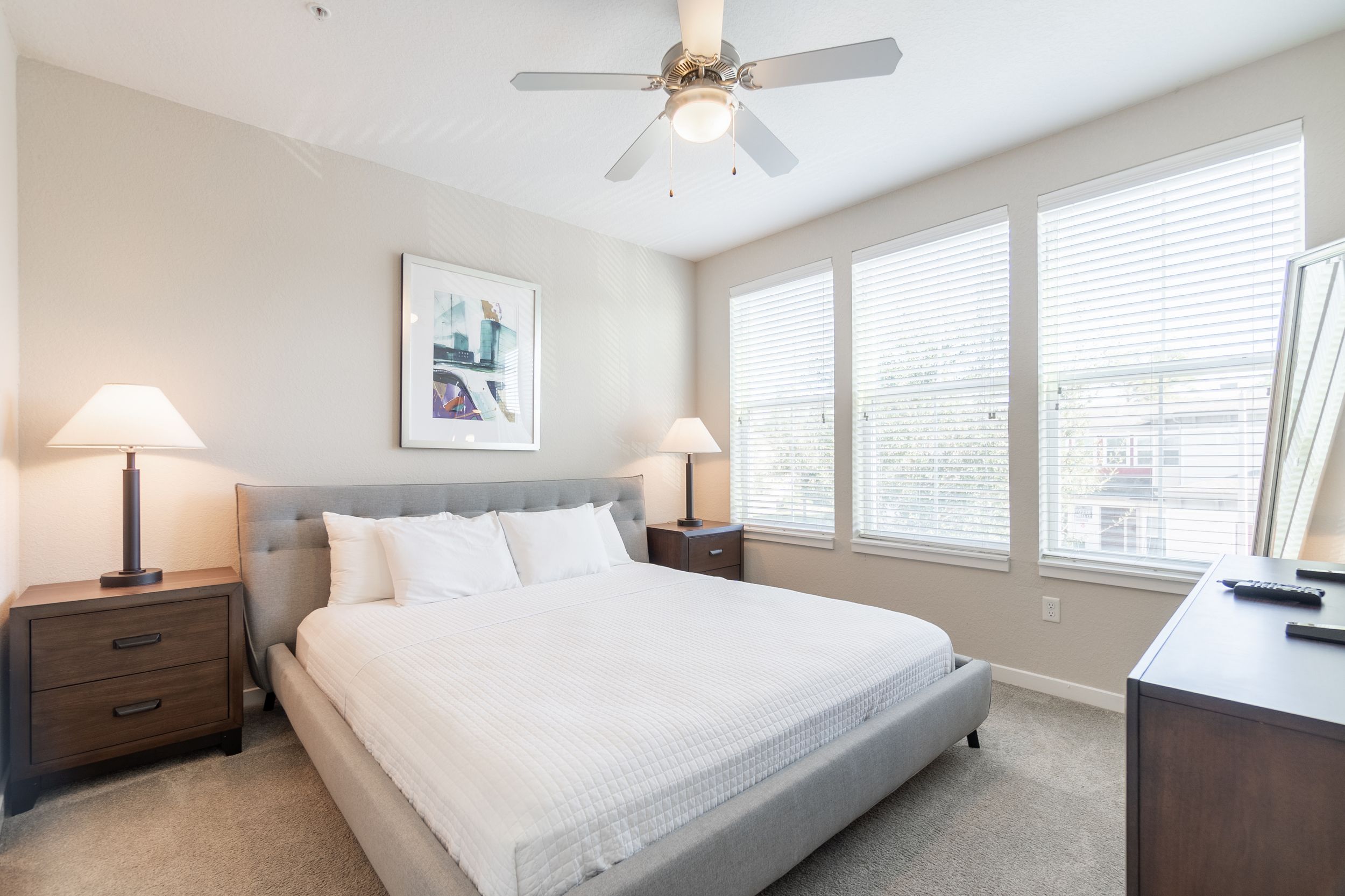 Furnished bedroom with carpet and ceiling fan