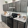 Apartment kitchen with black and stainless steel appliances