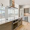 penthouse kitchen with glass top range and stainless steel appliances