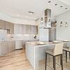 Kitchen with stainless steel appliances and island with seating and pendant lighting