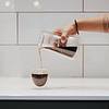Person pouring coffee in cup