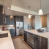 Kitchen with stainless steel appliances and island with pendant lighting