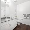 White bathroom with granite vanity