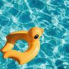 a yellow duck floatation device floating in a pool