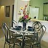 dining table and chairs with large flower arrangement