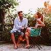 man and woman sitting outside and laughing
