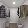 Walk in closet with wire racks and clothes hanging