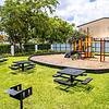 children's playground with picnic tables and grills