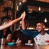 Man giving high five to his friend at restaurant