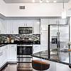 Kitchen with white cabinetry and stainless steel appliances 