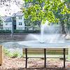 Community pond with water feature and bench