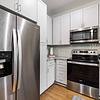 Kitchen with white cabinetry and stainless steel appliances