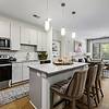 kitchen with white cabinets and island overlooking living room
