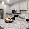 White kitchen with island and stainless steel appliances