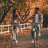 young couple with bicycles in the park in autumn