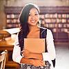 Picture of girl in library with folder in arms