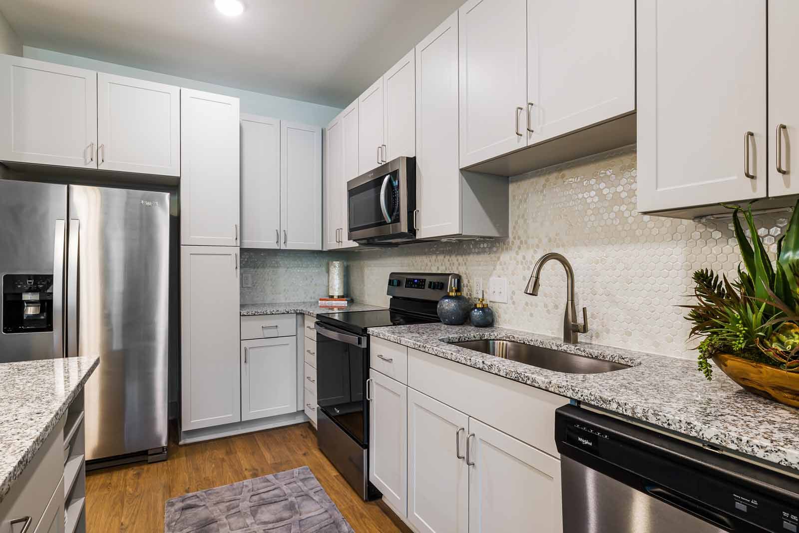 Kitchen with white cabinetry and stainless steel appliances