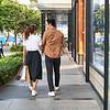 Couple walking down street and holding shopping bag