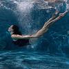 Woman swimming under water in the pool