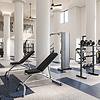 Fitness center with training equipment and blue and white flooring