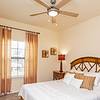 Furnished bedroom with window and ceiling fan