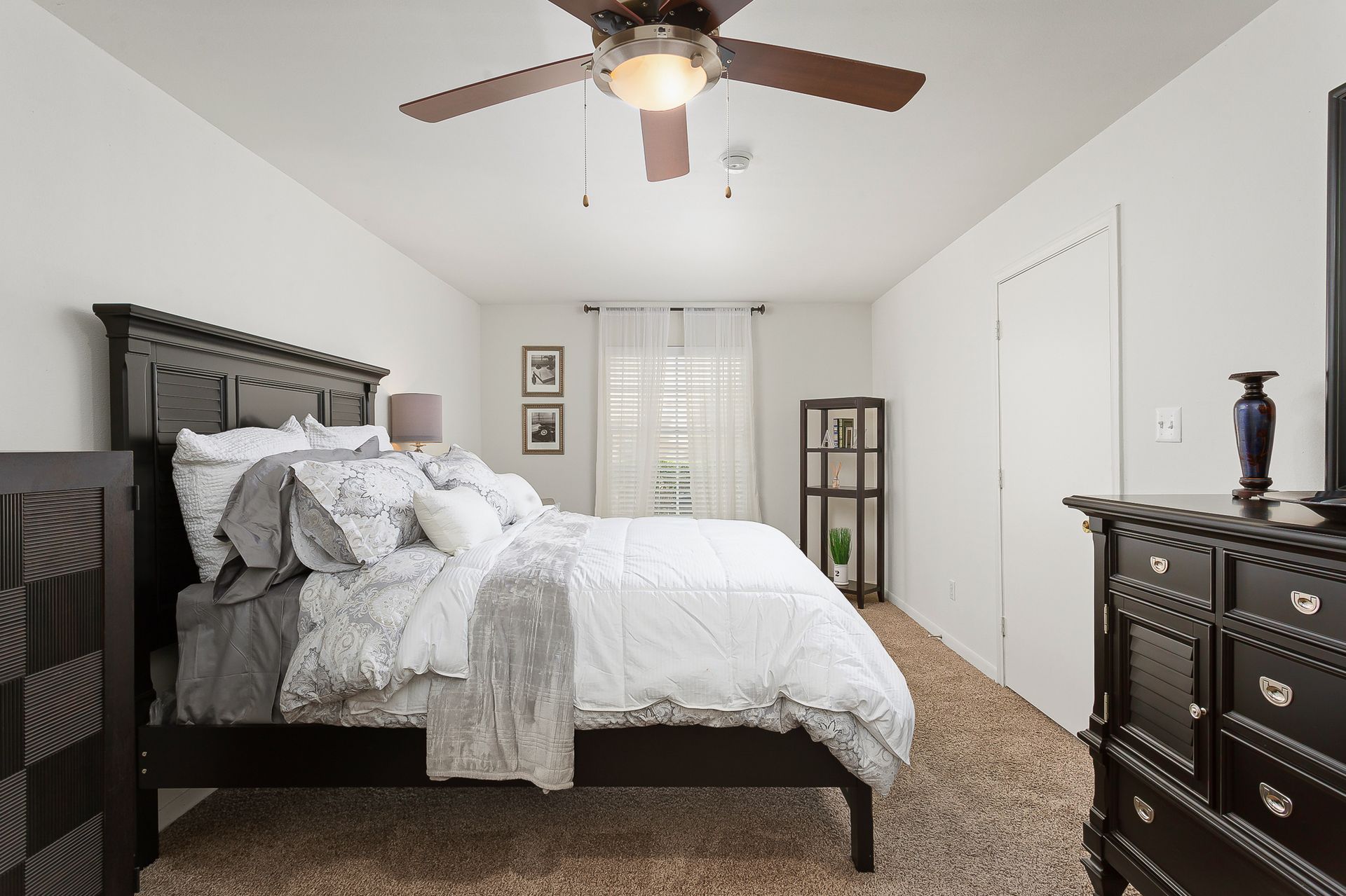 Furnished bedroom with carpet and ceiling fan