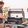 man and woman grilling meat