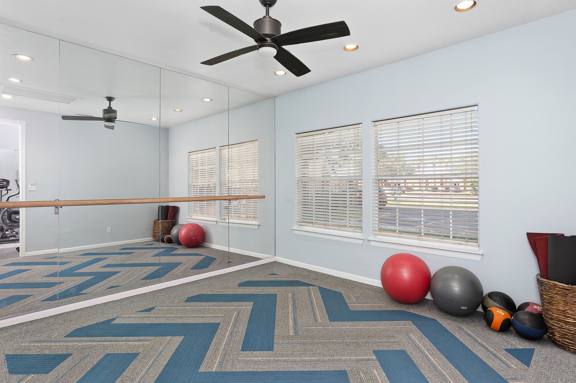 Yoga Room with large mirror and exercise equipment