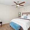 Furnished bedroom with ceiling fan