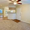 Unfurnished living room with carpet and view of kitchen