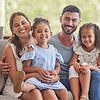 family sitting on couch smiling