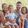family sitting on couch smiling