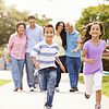 two children running ahead of their family