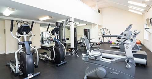 State of the art fitness center with cardio and strength training equipment and TV's