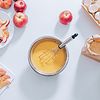 white table with apples, eggs and baking utensils on it