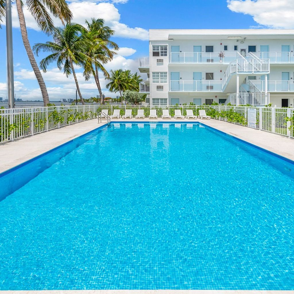 Pool deck Pool deck with palm trees and apartment building in background