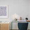 Stylish Interiors Interior living area of apartment with desk, art work on the walls and nick knacks at Solé Mia Rentals in North Miami, Florida