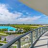 Private Balconies Balcony overlooking laguna with blue sky and palm trees in the distance at Solé Mia Rentals in North Miami, Florida