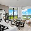 Your Private Oasis Apartment living area with couch, chairs, coffee table, large windows with view to laguna at Solé Mia Rentals in North Miami, Florida