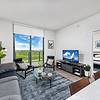 Stylish Interiors Apartment living area with couch, chairs, coffee table, large windows with view to laguna at Solé Mia Rentals in North Miami, Florida