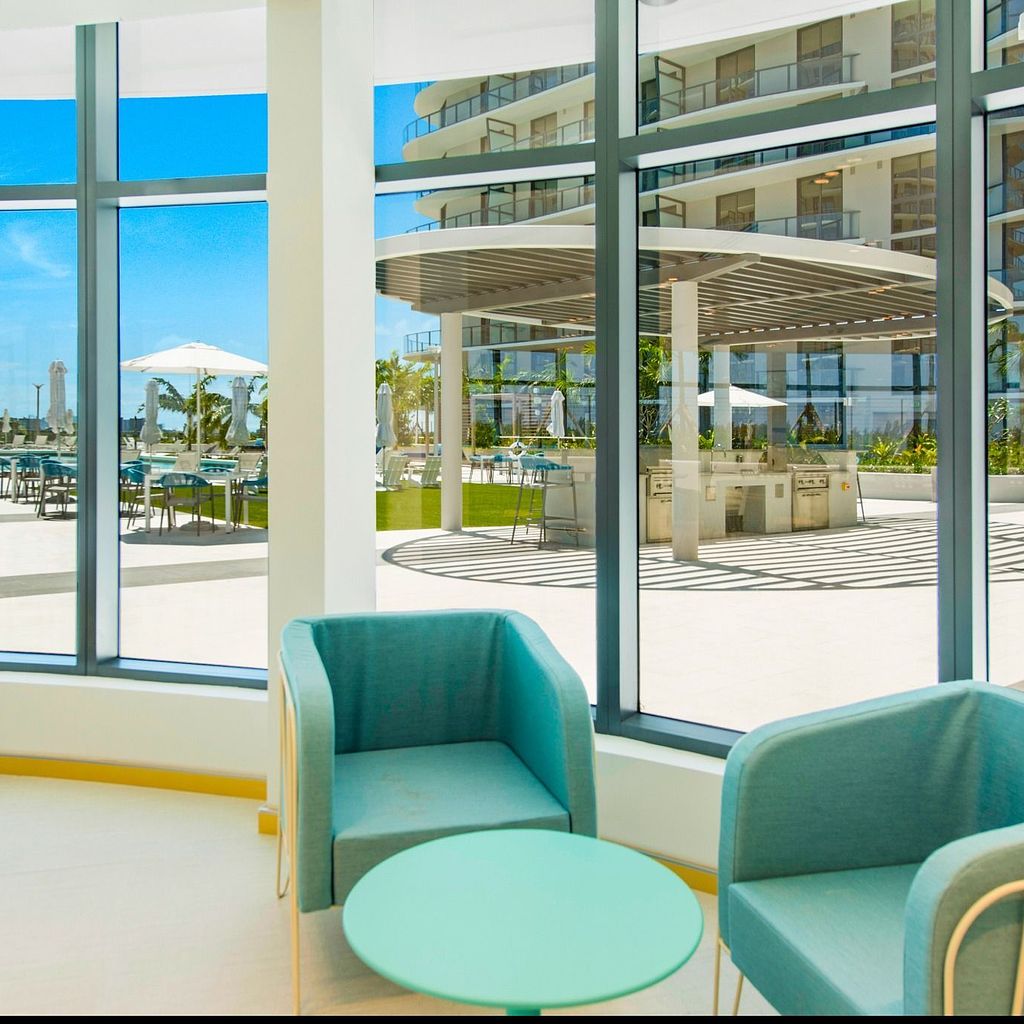 Resident Lounges Poolside Clubroom at The Shoreline at SoLé Mia Apartments in North Miami