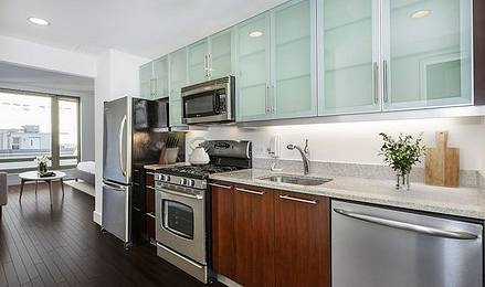 Apartment kitchen with stainless steel appliances and see-through cabinets