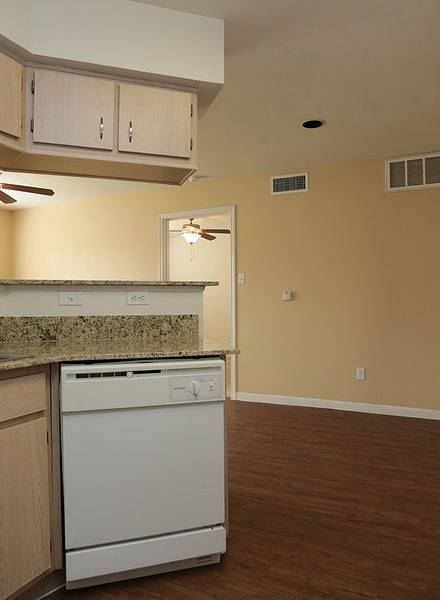 Kitchen with white appliances and hard flooring